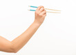 © serhii - hand holding chopsticks on white background isolated