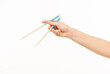 © serhii - hand holding chopsticks on white background isolated