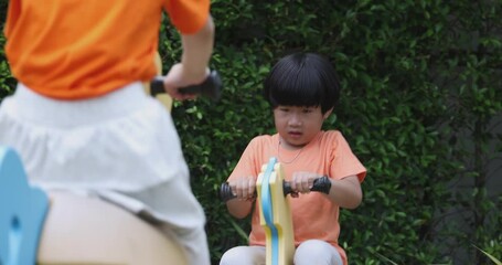 4k video slow motion asian children wear orange t-shirt play in playground. concept for funny and ac