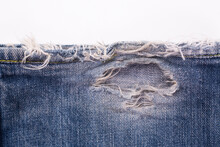 Blue Denim Jeans Tear Surface. Old Fabric Damaged Detail Texture Background.