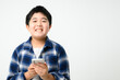 Child holding a smartphone, looking at the camera