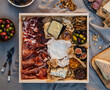 © Michael Marquand - Modern Charcuterie board with Brie, Blue Cheese, salami, prosciutto, figs, honey, jam, olives, crackers and nuts