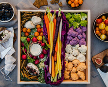 Appetizer Board Of Multi Colored Carrots, Cauliflower, Cheeses, Crackers, Beets, Tomatoes, And Dip