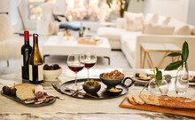 Table Setting With Appetizers Of Gourmet Cheese, Salami, Figs, Olives, Crackers, Bread And Red Wine