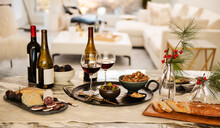 Table Setting With Appetizers Of Gourmet Cheese, Salami, Figs, Olives, Crackers, Bread And Red Wine
