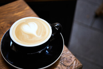 Cup of coffee on wooden table in cafe Cappuccino or latte in mug.