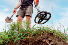 Metal Detector At Work In The Forest Or Field. Search For Treasure And Ancient Values. Archeology. Man With A Metal Detector. Minesweeper Image. ?lose-up
