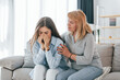 © standret - Woman supports her daughter. Mother and woman is together at home