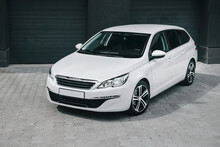 Compact White Executive Car, With Beautiful Wheels, Large Chrome Grille. Modern White Car.