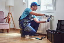 Central Heating Mechanic And Handyman Fixing Home Radiator, Gas Crisis And Seasonal Issues.