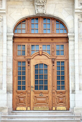 Wall Mural - Entrance of house with beautiful arched wooden door, elegant molding and transom window