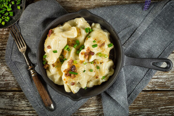 Wall Mural - Fried dumplings (pierogi) with meat filling sprinkled with greaves.