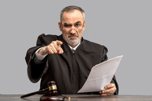 Judge Banging Judge's Gavel, Index Finger Pointing. Law Lord Wearing Gown Using A Hammer For Attention And Verdict, Justice Judgment At Courts Of Law