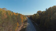 FPV drone high-speed flight along the road and autumn forest in Ural
