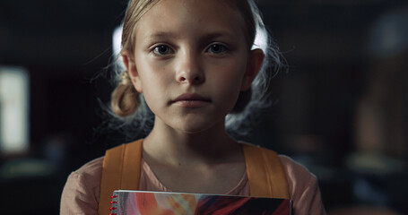 Sticker - Upset girl holding notebook standing school hall closeup. Schoolgirl frightened 