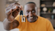 © Yuliia - Mature african american man happy homeowner male realtor buyer showing bunch of keys from new estate apartment rented house excited happy adult senior grandfather win flat modern housing improvement
