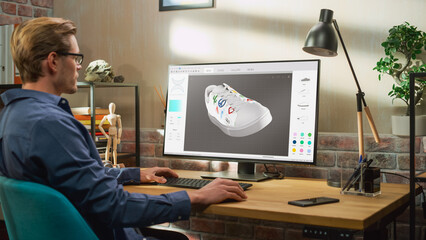 Poster - Young Male Footwear Designer Works on 3d Model of Shoe and Change Colours on It While Working on Desktop Computer in Creative Space. Shoe Production Procedure Concept.