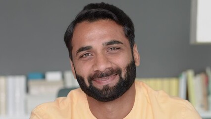 Wall Mural - Happy smiling positive handsome wealthy bearded 30s indian ethnic man looking at camera feeling cheerful, relaxed and satisfied at home indoors. Close up front male face portrait.