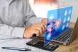 © NongAsimo - Businessman with engineering work on virtual screen concept, Man use a laptop computer, ideas for work planning efficiency, calculator pen and drawing on wood table