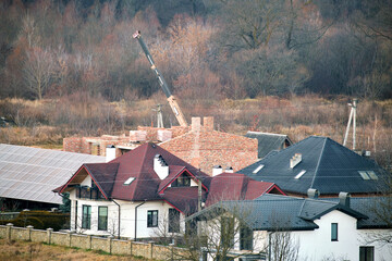 Wall Mural - Residential houses with roof tops covered with metallic and ceramic shingles in rural suburban area