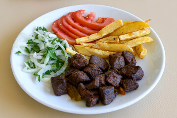 Beef steak grill with rice pilaf, fried potatoes, grilled pepper and tomatoes.Mix Platter with Beef rips, Cutlets, Potatoes and Sauces.