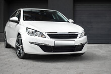 Compact White Executive Car, With Beautiful Wheels, Large Chrome Grille. Modern White Car.