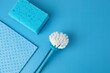 cleaning and housekeeping, stylish cleaning accessories, washing tools, brush sponge and rag on blue background, copy space