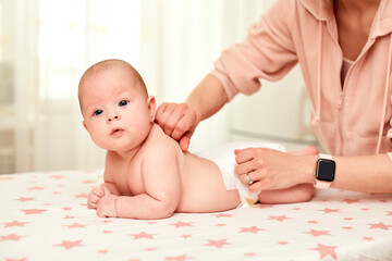 Baby massage. Mother massaging her newborn baby.