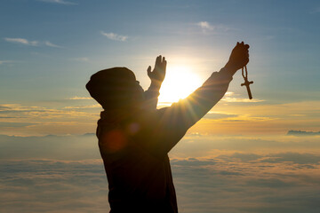 Wall Mural - The human hand raises his palm open to worship. Eucharist, bless the Lord, help Catholics repent of Easter. behind the concept of Christianity Battle and Victory for God