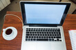 © AVI Pix - open laptop on a wooden table, coffee cup and blank notebook next to it