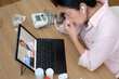 © weedezign - asian woman telemedicine doctor online visit with computer at home