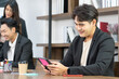 © Wongsakorn - Business people using smartphone in office. Portrait of an handsome businessman. Modern businessman.
