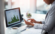 © C Malambo/peopleimages.com - An accountant working on growth, tax review or expenses of a company with graphs or charts on a laptop screen. Closeup of a financial advisor typing on a phone while analyzing business statistics