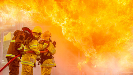 Fireman,Firefighter training Firefighters using water and fire extinguishers to fight the flames in emergency situations. in a dangerous situation All firefighters wear firefighter uniforms for safety