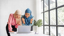 Young Pretty Female Startup Partners Islamic People Raise Their Hands To Congratulate When Working With Laptop, Read A Good Email News, Successful Concept.