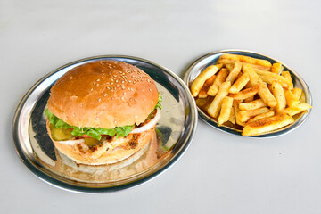 Big tasty burger with beef cutlet on a plate. Crispy chicken burger.