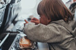 © Ksenia - little candid kid boy five years old eats burger or sandwich food sitting in airplane seat on flight traveling from airport. children take a bite. child in air plane eating lunch or dinner meal