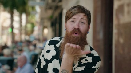 Poster - Young redhead man smiling confident doing kiss gesture with hand at street