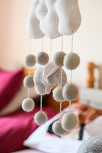 Close-Up Of A Crib Mobile Hanging Over A Baby Cot In A Bedroom