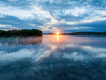 Aerial View Of Sunset Over Calm Lake During Midnight Sun In Overtornea, Sweden.