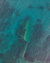 Aerial View Of A Sunken Shipwreck Near The Rocks Along The Coast In Pomonte, Elba Island, Tuscany, Italy.