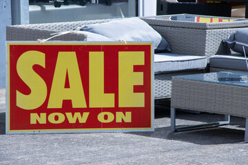 sale now on sign at outdoor furniture store