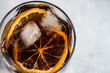 © RooM The Agency - Overhead view of a cola drink with ice cubes and slices of orange