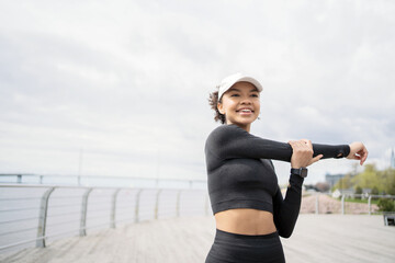 Wall Mural - A female athlete does active fitness exercises, lifestyle, uses a fitness watch and a tracker to measure her pulse