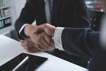 Wall Mural - Business deal. Two businessmen shaking hand in meeting room at modern office, congratulation, investor, success, business interview, partnership, handshake, teamwork, co-working concept 