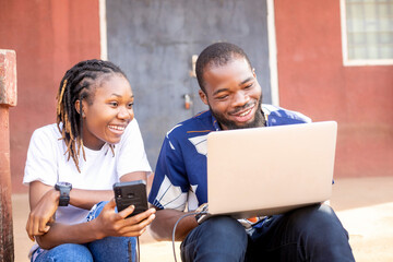 two african student using laptop computer and mobile checking assignment or school project on the in