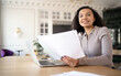 © muse studio - A woman in the office works with documents, responds to the client