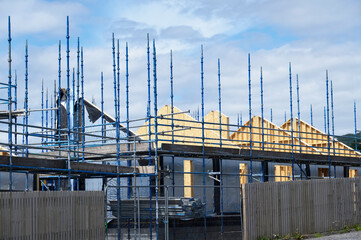 Wall Mural - Scaffolding surrounding house development for safe access to construction work