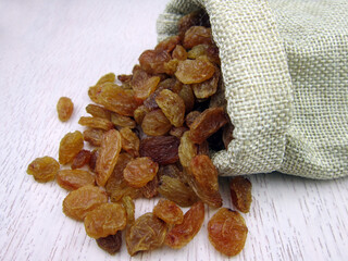 Wall Mural -     Raisins in burlap bag on wooden table            