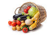 Overturned basket with vegetables on a white background
